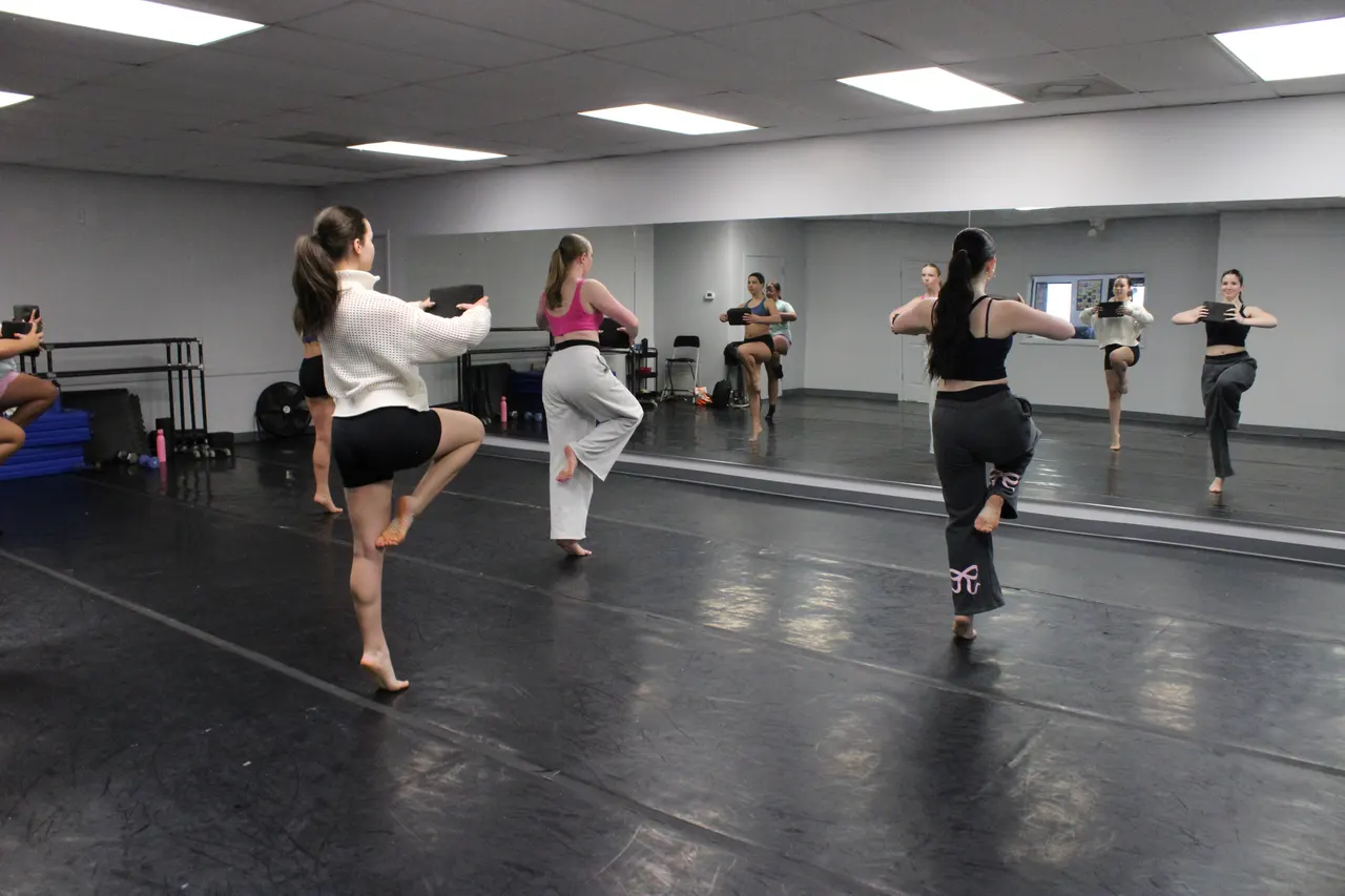 Dancers in class at the studio mirror